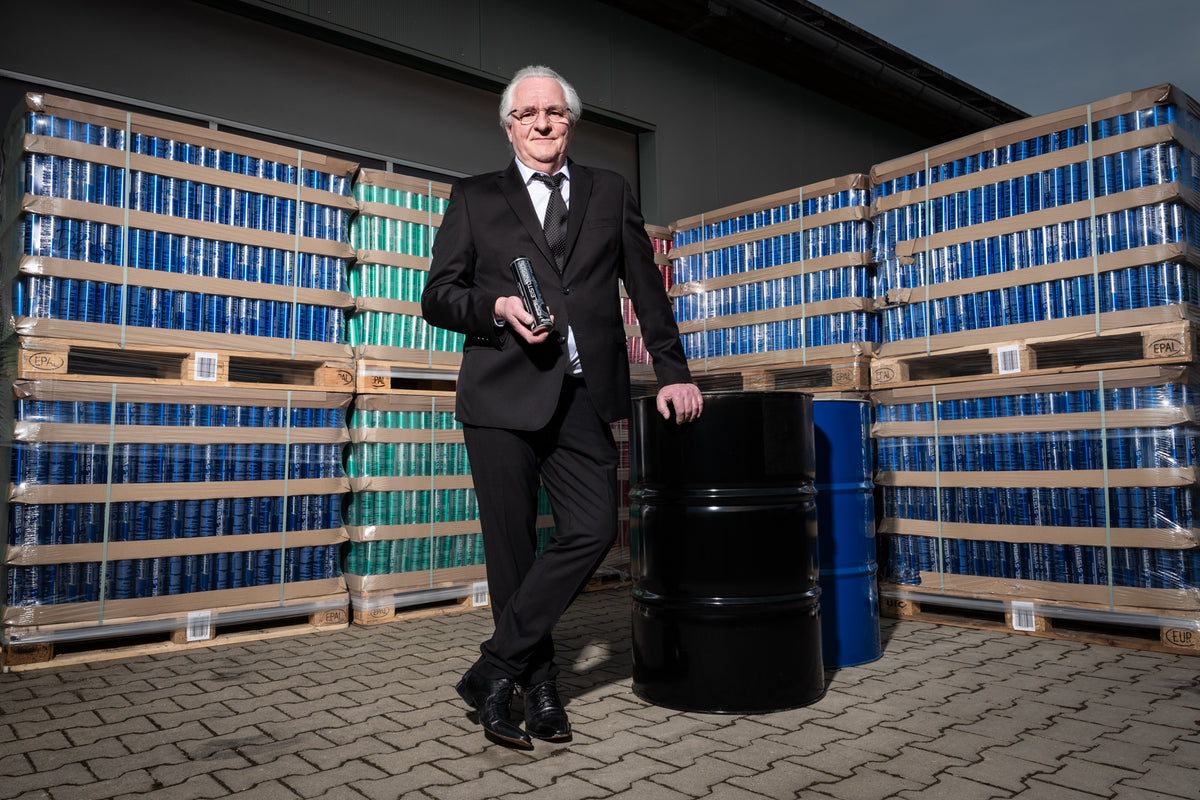 Helmut Ohnheiser with EUROSOL High Performance Oil Additive in front of the product warehouse